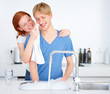 Photo: Young girl wiping boyfriend's nose in the kitchen Young girl wiping boyfriend's nose in the kitchen