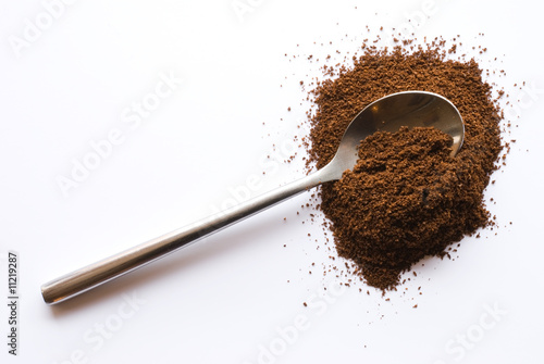 Photo: Spoon with coffee on clipping background Spoon with coffee on clipping background