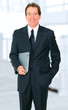 Successful Senior Businessman Holding Book