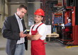 boss talking to worker in uniform in factory