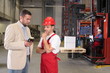 boss talking to worker in uniform in factory