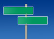 Road sign against blue sky