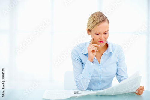 Young businesswoman reading newspaper isolated Young businesswoman reading newspaper isolated