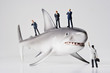 Business figurines placed with a shark figurine.