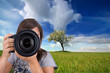 young female photographer with digital photo camera shooting lan