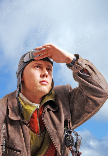 Photo: pilot in old uniform looking upstairs to the sky pilot in old uniform looking upstairs to the sky