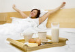 Young woman has a breakfast in the bed