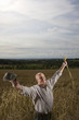 Farmer standing in wheat field