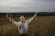 Farmer standing in wheat field