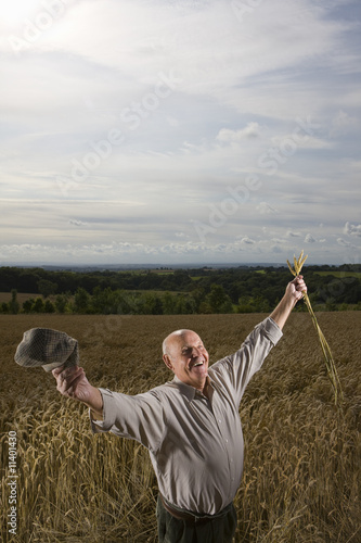 Photo: Farmer standing in wheat field Farmer standing in wheat field