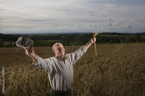 Photo: Farmer standing in wheat field Farmer standing in wheat field
