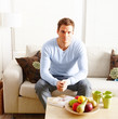 Modern lifestyle - young man sitting on couch