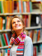 Young smiling lady looking upwards in library Young smiling lady looking upwards in library