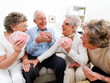 Foto: Group of happy people enjoying a card game Group of happy people enjoying a card game