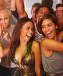 Young men and women dancing at nightclub Young men and women dancing at nightclub