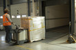 Photo: worker loading truck with electric pallet truck worker loading truck with electric pallet truck