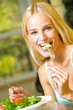 Portrait of young happy smiling woman eating salad Portrait of young happy smiling woman eating salad