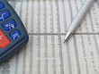 Stock quotes with pen and calculator