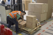 Photo: Warehouse operative moving stock from pallet Warehouse operative moving stock from pallet