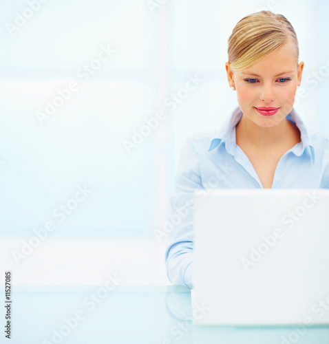 Photo: Portrait of a smiling beautiful young business woman working on Portrait of a smiling beautiful young business woman working on