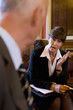 Female registrar on chair in conversation with man