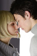attractive couple with eyes closed faceing each others