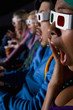 Audience in cinema wearing 3D glasses, close-up