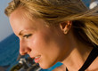 blonde female looking into sun in resort