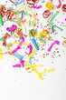 Photo: confetti and colorful blowers on white background confetti and colorful blowers on white background