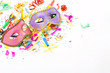 carnival masks and colorful confetti on white