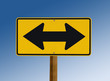 Yellow street sign with two arrows Yellow street sign with two arrows