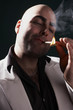 Photo: man in a suit lighting a cigar man in a suit lighting a cigar
