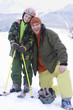 Portrait of father and son on ski slope