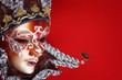 ornate carnival mask over textured metallic background