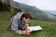 Man with backpack looking to the map