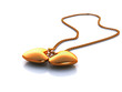 Gold medallion with two hearts on a chain, on a white background