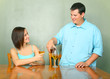 Young Couple Enjoying Wine On Kitchen Table