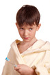 A boy brushing his teeth after bath