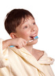 A boy brushing his teeth after bath
