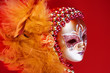 ornate carnival mask over textured metallic background