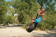 Girl playing with tire swing