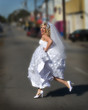 beautiful bride running across street