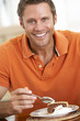 Middle Aged Man Eating Chocolate Cake
