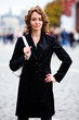 Smiling woman standing by Kremlin in Moscow