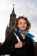 Smiling woman standing by Kremlin in Moscow
