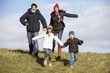 Family Running In The Park