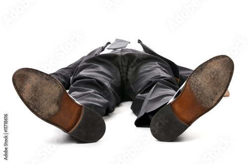 Photo: Businessman laying down on white background Businessman laying down on white background