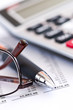 Tax calculator pen and glasses Tax calculator pen and glasses