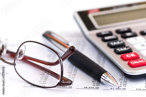Photo: Tax calculator pen and glasses Tax calculator pen and glasses