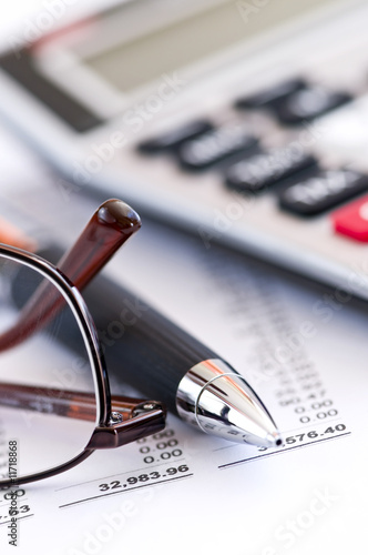 Photo: Tax calculator pen and glasses Tax calculator pen and glasses